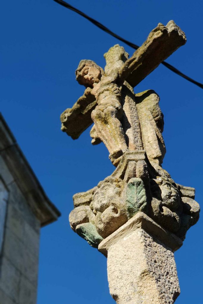 Jesus on the cross in front of the church Santa Mariña